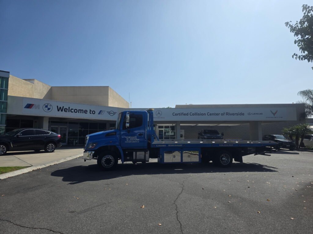 Team Smith Logistics flatbed outside the Certified Collision Center of Riverside